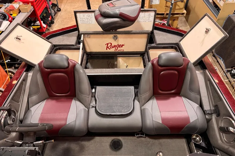 Slide: The Image of 2017 Ranger Z520 Comanche boat interior with red and gray seats, open storage compartments. - 6