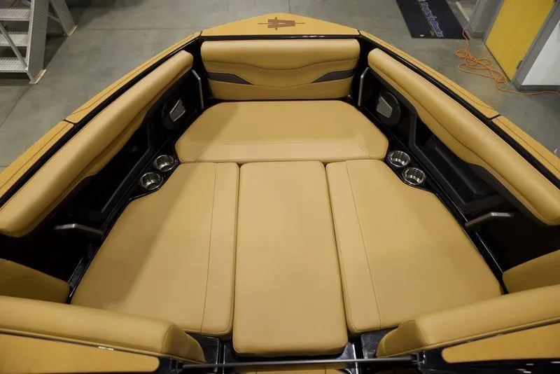 Slide: The Image of 2025 Axis T250 boat interior with tan leather seating and cup holders. - 13