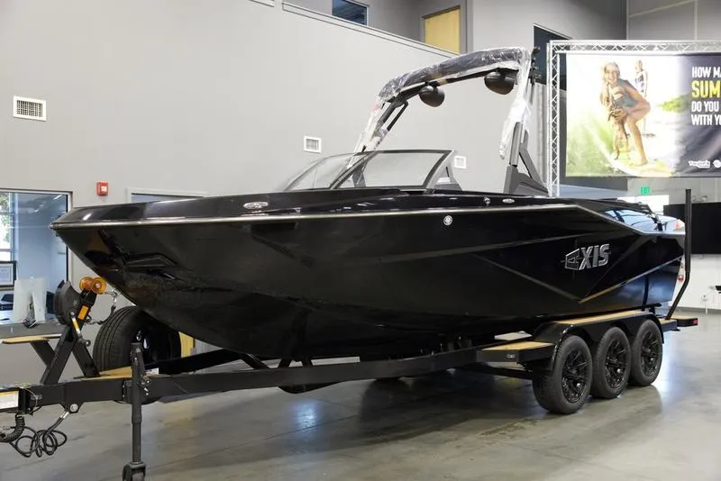 Slide: The Image of 2025 Axis T250 black boat on trailer in showroom. - 3