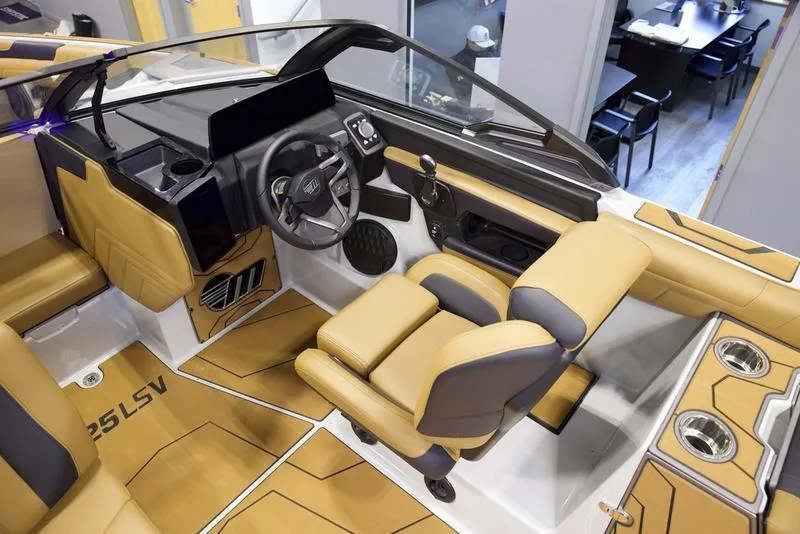 Slide: The Image of Interior of 2025 Malibu 25 LSV boat with tan and black seating. - 13