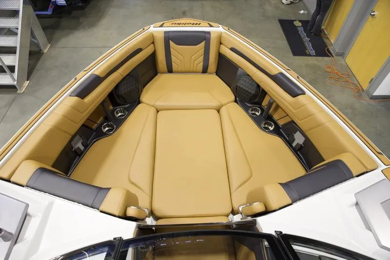 Slide: The Image of 2025 Malibu 25 LSV boat interior with luxurious tan seating and cup holders. - 18