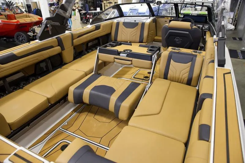 Slide: The Image of Luxurious interior of 2025 Malibu 25 LSV boat with tan and black seating. - 22