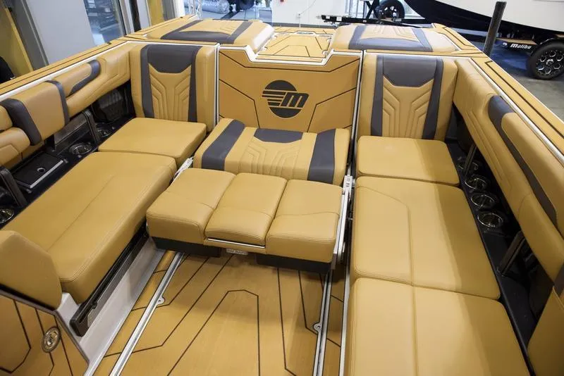 Slide: The Image of Luxurious interior of 2025 Malibu 25 LSV boat with tan and black seating. - 23