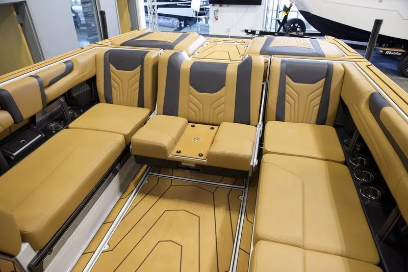 Slide: The Image of Luxurious interior of 2025 Malibu 25 LSV boat with tan and gray seating. - 24