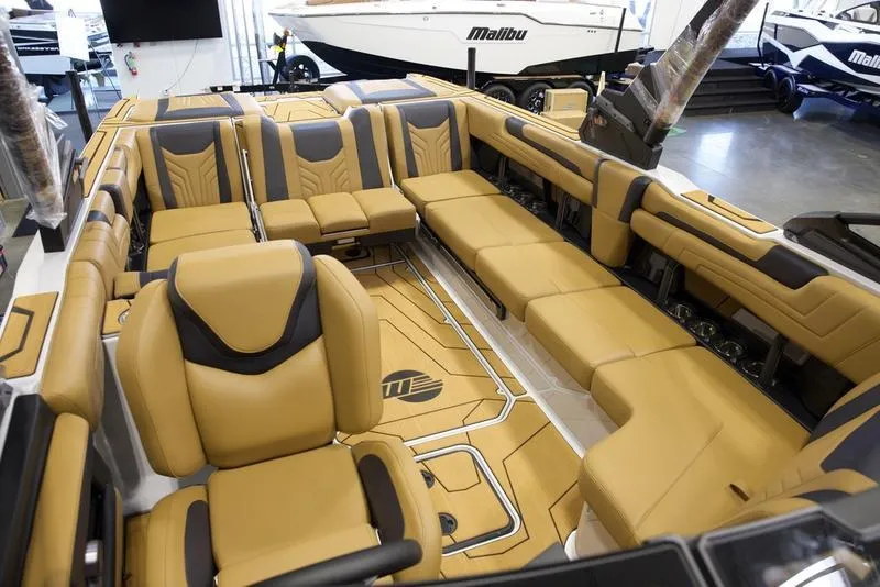 Slide: The Image of Luxurious interior of 2025 Malibu 25 LSV boat with tan seating and modern design. - 26