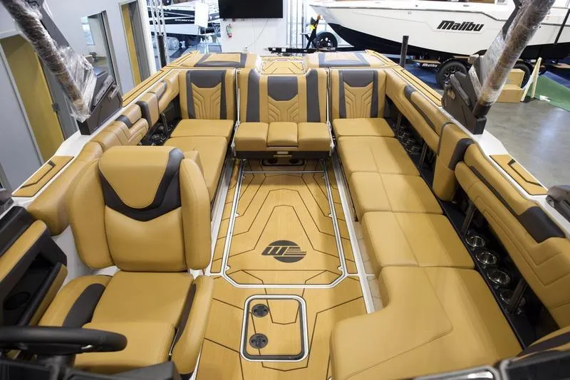Slide: The Image of Luxurious interior of 2025 Malibu 25 LSV boat with tan leather seating. - 27