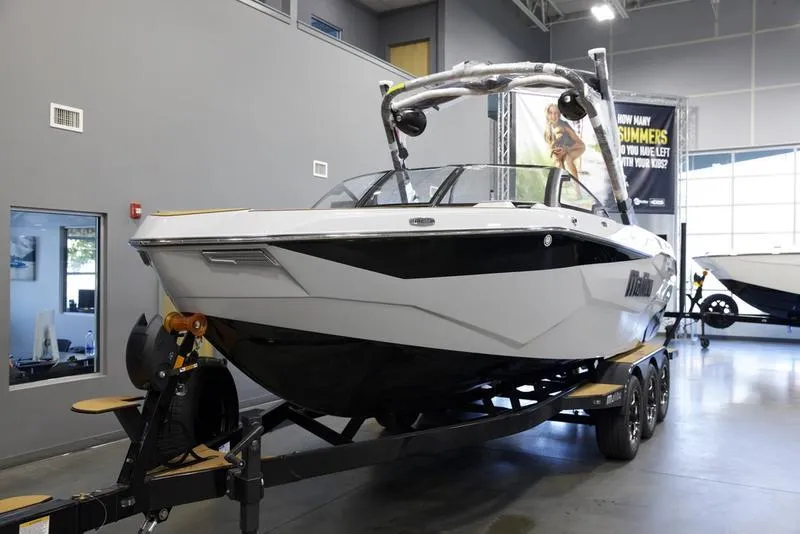 Slide: The Image of 2025 Malibu 25 LSV boat on trailer in showroom. - 3