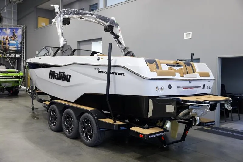 Slide: The Image of 2025 Malibu 25 LSV boat on trailer in showroom, rear view. - 4