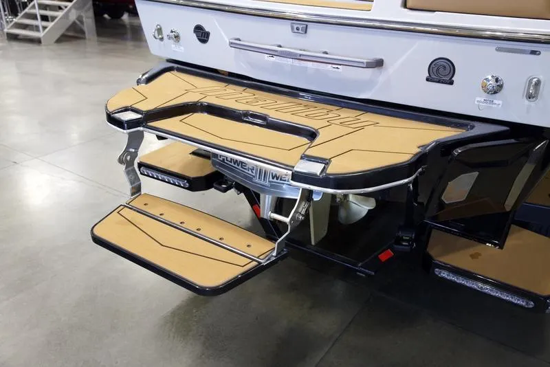 Slide: The Image of 2025 Malibu 25 LSV boat with tan swim platform and step ladder. - 5