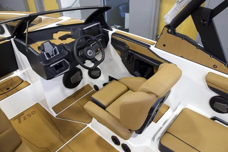 Slide: The Image of 2025 Axis T250 boat interior with tan seats and modern dashboard design. - 10