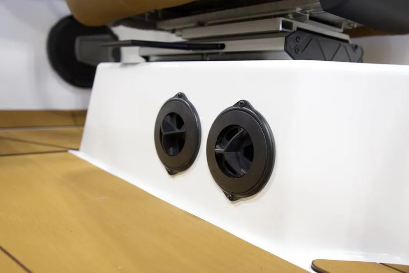 Slide: The Image of 2025 Axis T250 boat interior detail with dual black vents on white panel. - 14