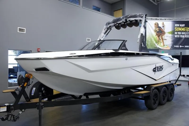 Slide: The Image of 2025 Axis T250 boat on trailer in showroom. - 3