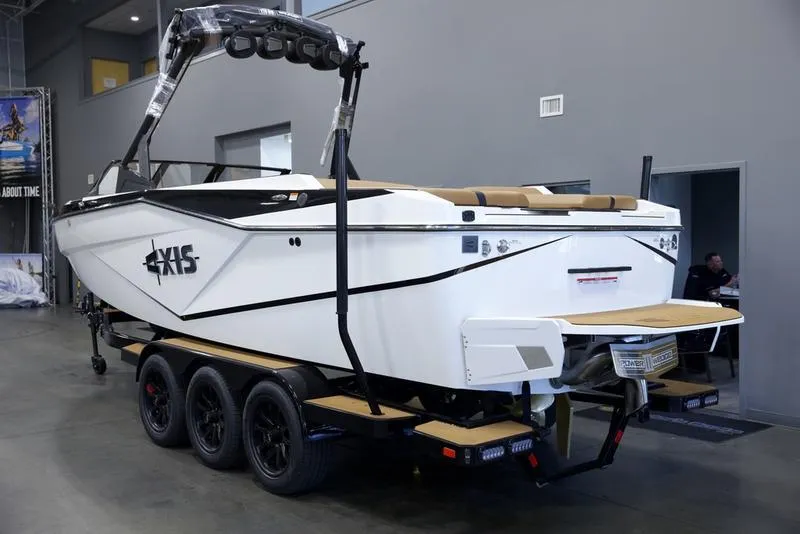 Slide: The Image of 2025 Axis T250 boat on trailer in showroom, featuring sleek design and modern amenities. - 4