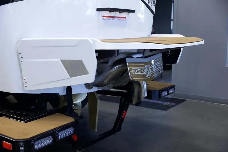 Slide: The Image of 2025 Axis T250 boat rear view with swim platform and exhaust system. - 5