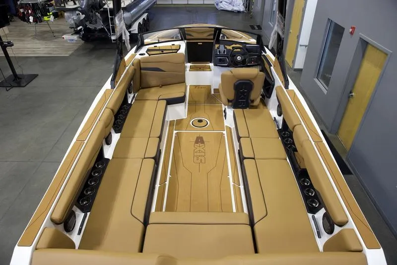 Slide: The Image of 2025 Axis T250 boat interior with tan seating and modern dashboard. - 9