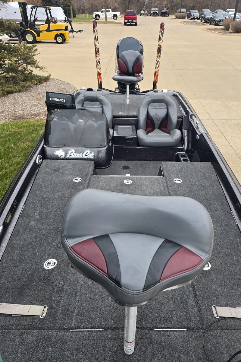 Slide: The Image of 2010 Bass Cat Cougar FTD boat interior with gray and red seating. - 3