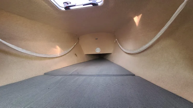 Slide: The Image of Interior cabin of 2013 Corsair Dash 750 MKII sailboat, featuring spacious layout and textured flooring. - 10