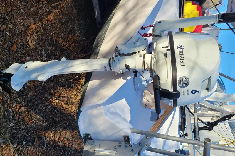 Slide: The Image of Outboard motor on Corsair Dash 750 MKII sailboat, 2013 model, parked on dry leaves. - 22