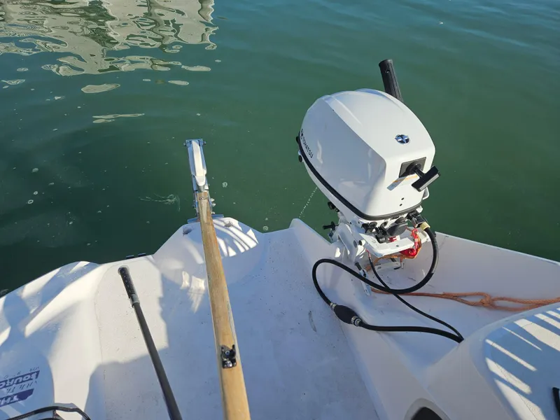 Slide: The Image of Corsair Dash 750 MKII boat with motor and oar on calm water, 2013 model. - 6