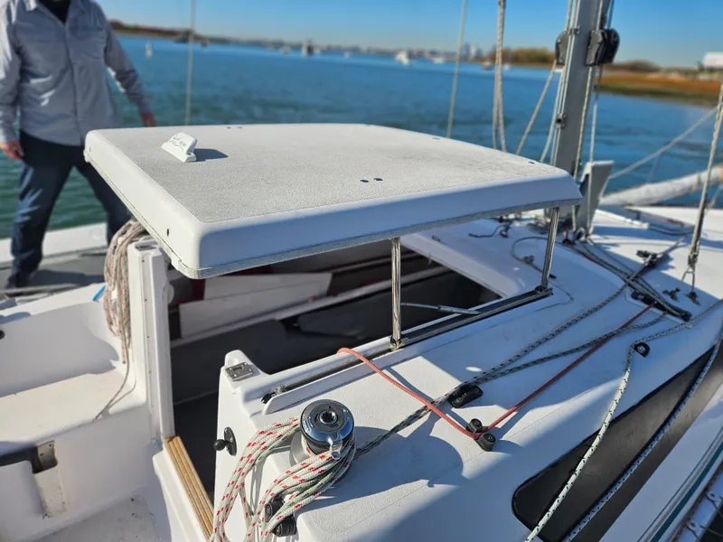 Slide: The Image of Sailboat cockpit of 2013 Corsair Dash 750 MKII on water, featuring ropes and winch. - 7