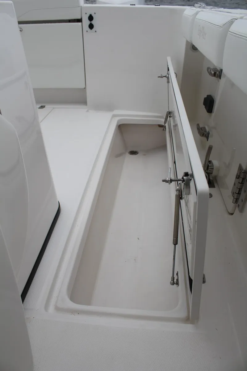 Slide: The Image of 2019 Edgewater 370CC boat storage compartment with open hatch, showcasing spacious interior. - 32