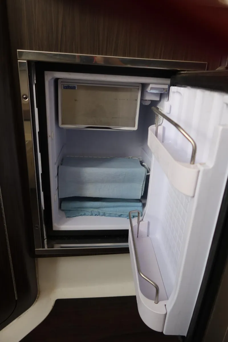 Slide: The Image of Open mini fridge inside 2019 Edgewater 370CC boat cabin. - 34