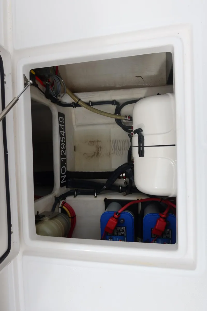 Slide: The Image of 2019 Edgewater 370CC boat compartment with batteries and equipment. - 36