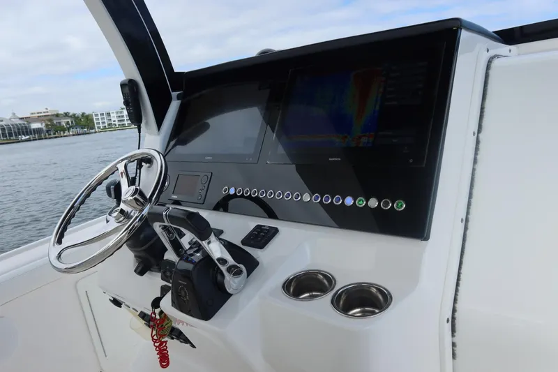 Slide: The Image of Edgewater 370CC 2019 boat dashboard with steering wheel and control panel. - 39