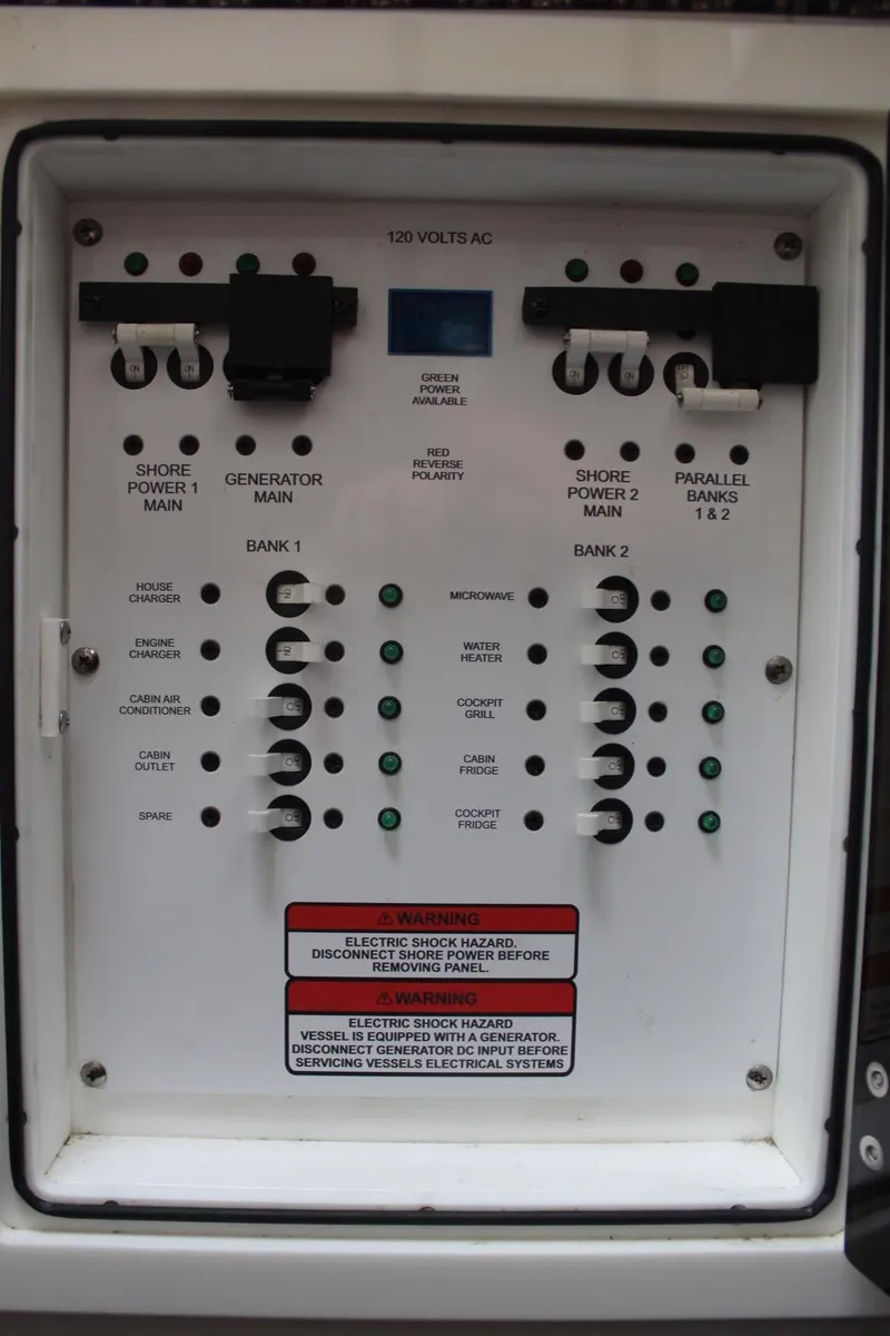 Slide: The Image of Electrical panel of 2019 Edgewater 370CC boat, showing circuit breakers and controls. - 45