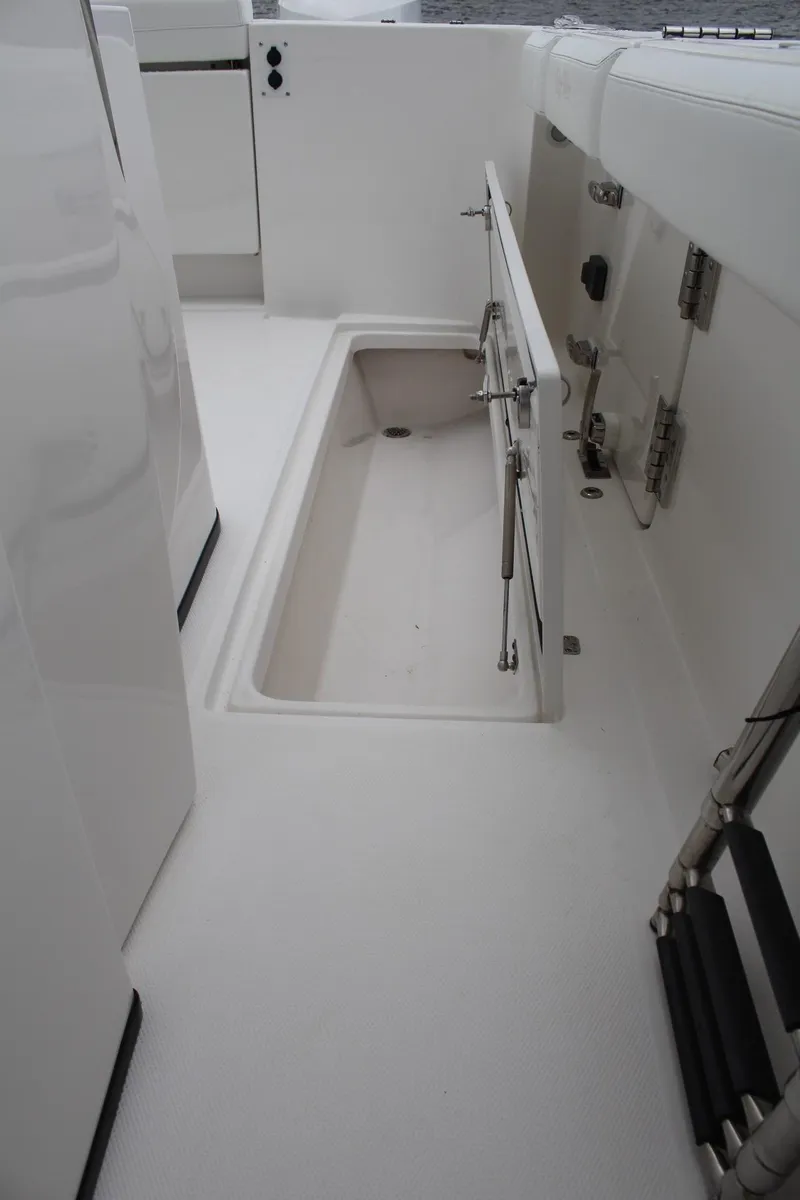 Slide: The Image of 2019 Edgewater 370CC boat interior with open storage compartment. - 47
