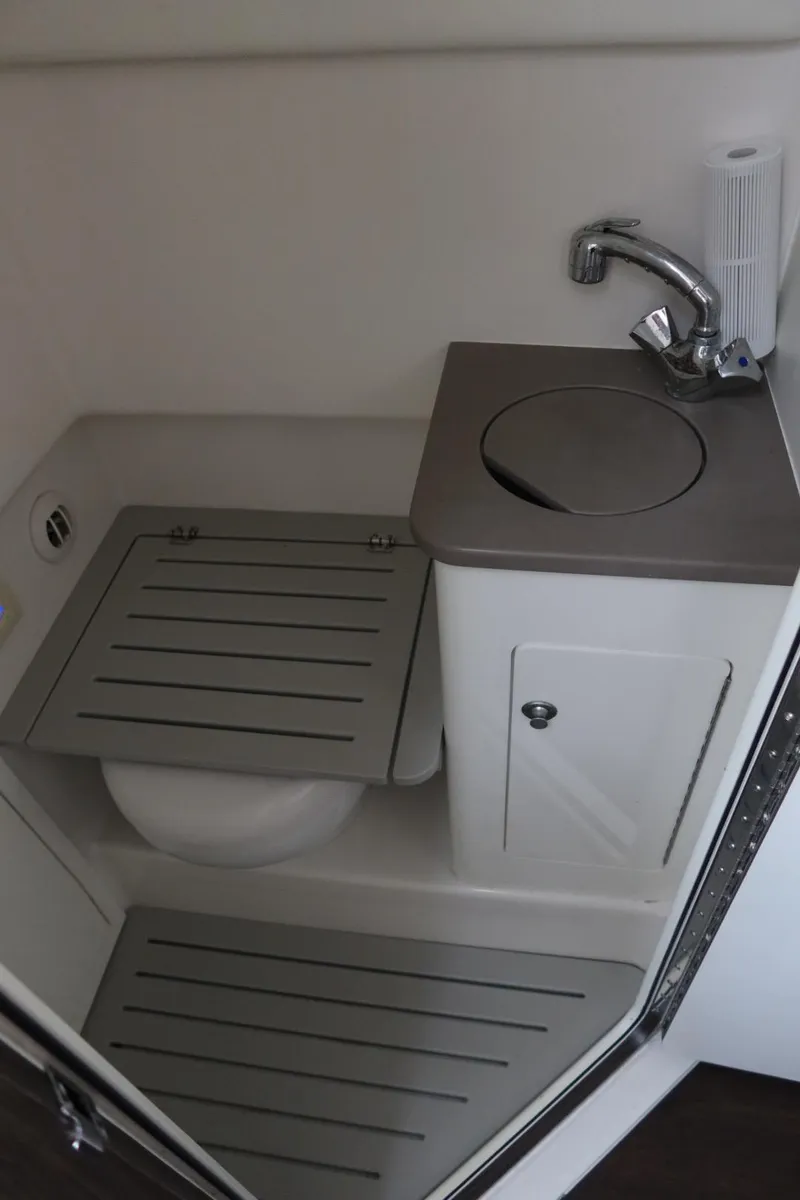 Slide: The Image of 2019 Edgewater 370CC boat bathroom with compact sink and toilet. - 48