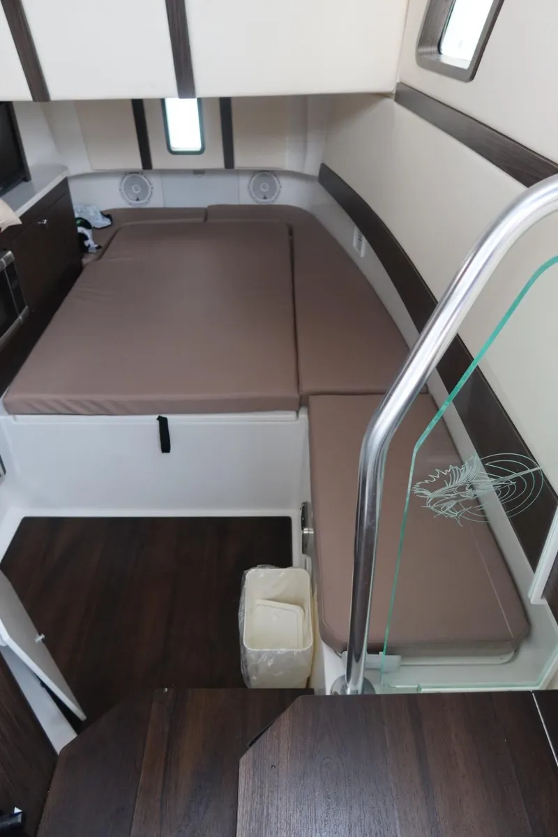 Slide: The Image of 2019 Edgewater 370CC cabin interior with brown cushions and modern design. - 49