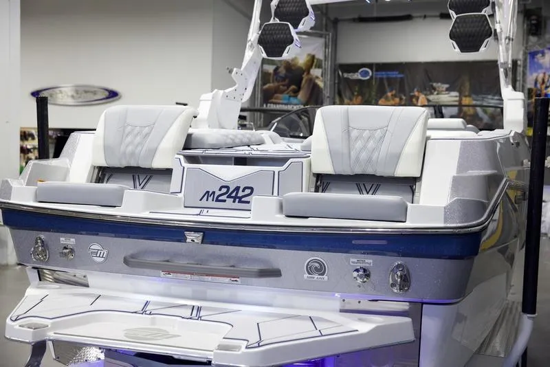 Slide: The Image of 2025 Malibu M242 boat interior with modern seating and sleek design. - 11
