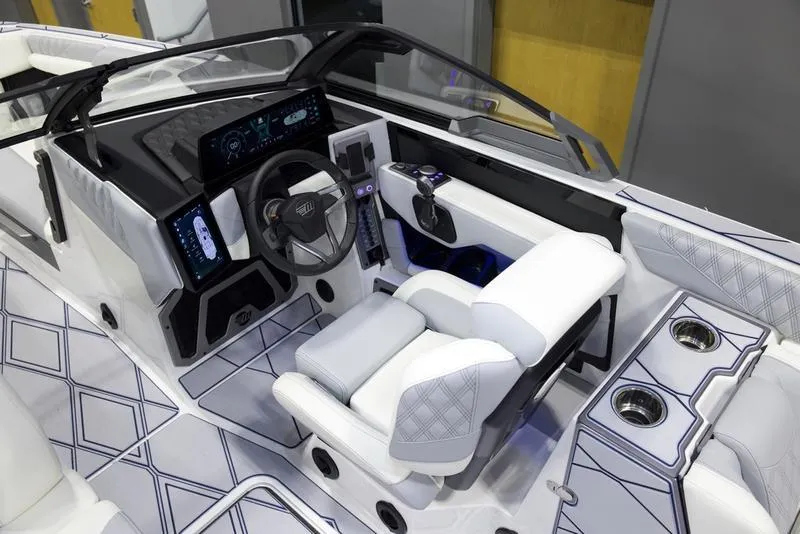 Slide: The Image of 2025 Malibu M242 boat interior with modern dashboard and luxurious seating. - 13
