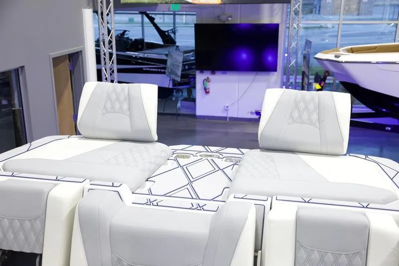 Slide: The Image of 2025 Malibu M242 boat interior with modern seating and stylish design. - 28