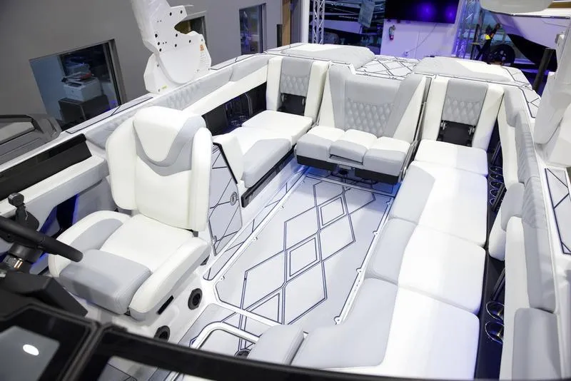 Slide: The Image of Luxurious interior of 2025 Malibu M242 boat with white seating and modern design. - 29