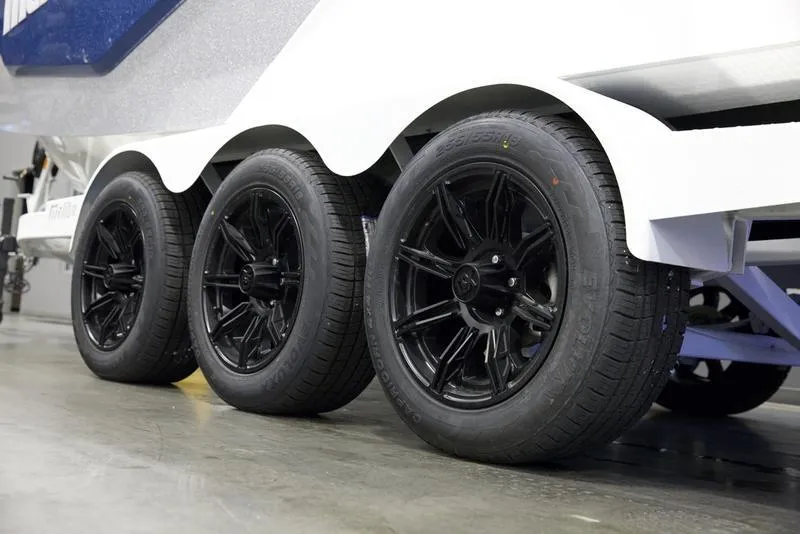 Slide: The Image of 2025 Malibu M242 trailer with sleek black wheels in a showroom setting. - 8