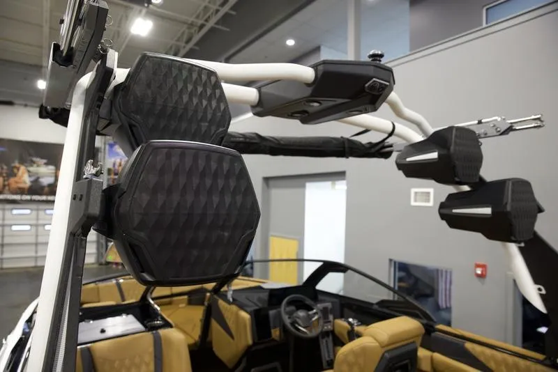 Slide: The Image of 2025 Malibu M230 boat interior with advanced speaker system and luxurious seating. - 14