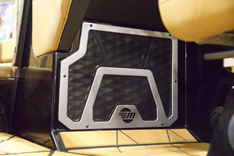 Slide: The Image of 2025 Malibu M230 interior speaker detail with modern design and beige upholstery. - 17