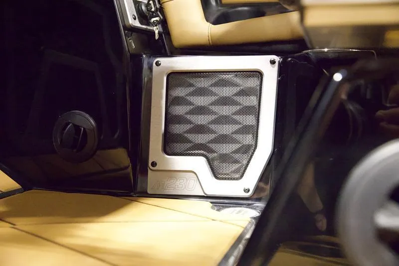 Slide: The Image of 2025 Malibu M230 interior speaker detail with beige upholstery and sleek design. - 19