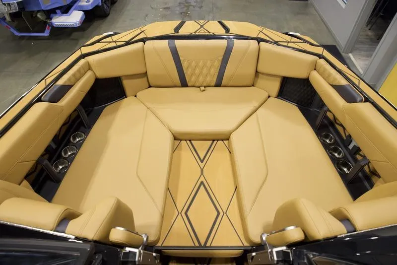 Slide: The Image of 2025 Malibu M230 boat interior with luxurious tan seating and modern design. - 20