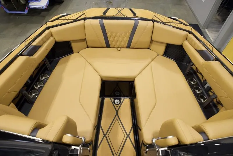 Slide: The Image of Luxurious interior of 2025 Malibu M230 boat with tan seating and cup holders. - 22