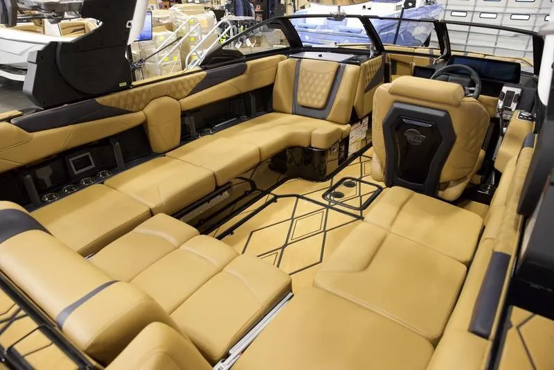 Slide: The Image of Luxurious interior of 2025 Malibu M230 boat with tan leather seating and modern design. - 23