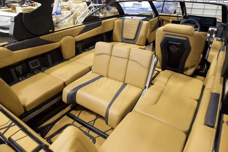 Slide: The Image of Luxurious interior of 2025 Malibu M230 boat with tan leather seating. - 24