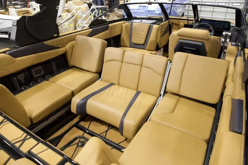 Slide: The Image of Luxurious interior of 2025 Malibu M230 boat with tan leather seating and modern design. - 25