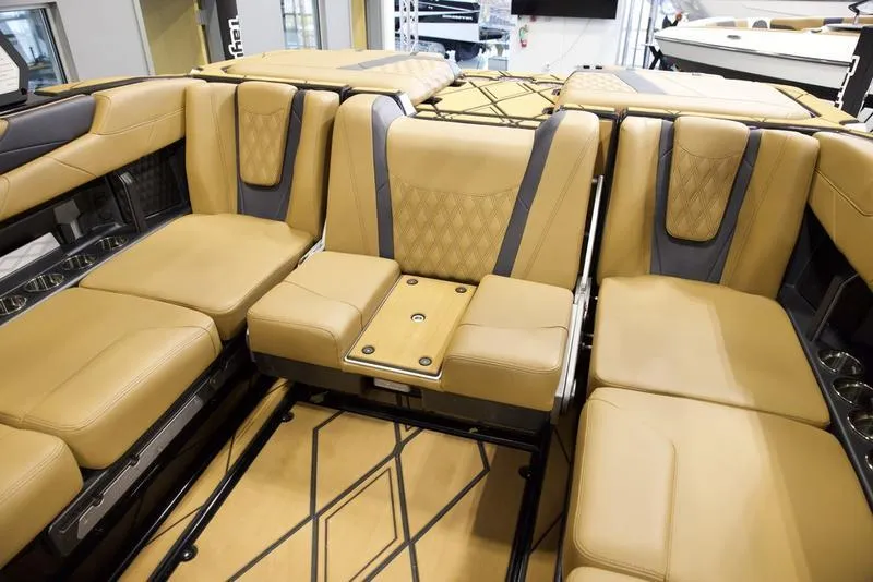 Slide: The Image of Luxurious interior of 2025 Malibu M230 boat with tan leather seating and modern design. - 26
