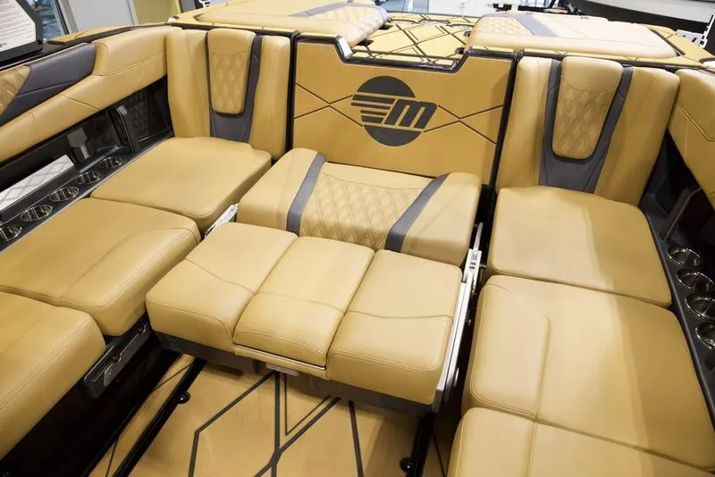 Slide: The Image of Luxurious interior seating of 2025 Malibu M230 boat with tan upholstery and modern design. - 27