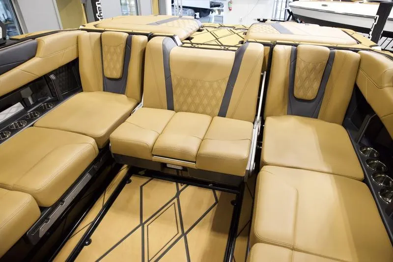 Slide: The Image of Luxurious interior seating of 2025 Malibu M230 boat with tan upholstery. - 28