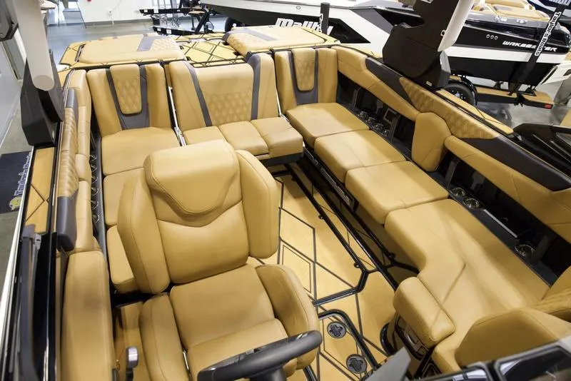 Slide: The Image of Luxurious interior of 2025 Malibu M230 boat with tan leather seating. - 29