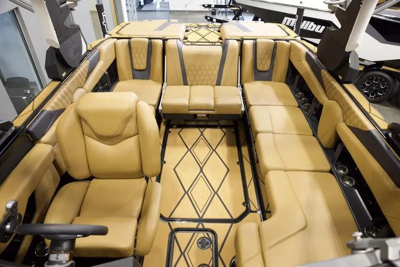Slide: The Image of Luxurious interior of 2025 Malibu M230 boat with tan leather seating and modern design. - 30